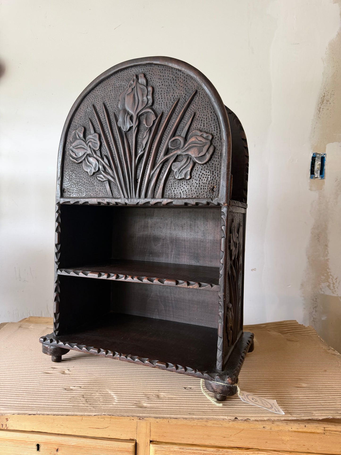 Carved wooden iris magazine stand