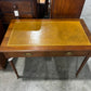 Edwardian ochre leather topped writing desk with two drawers and caster wheels