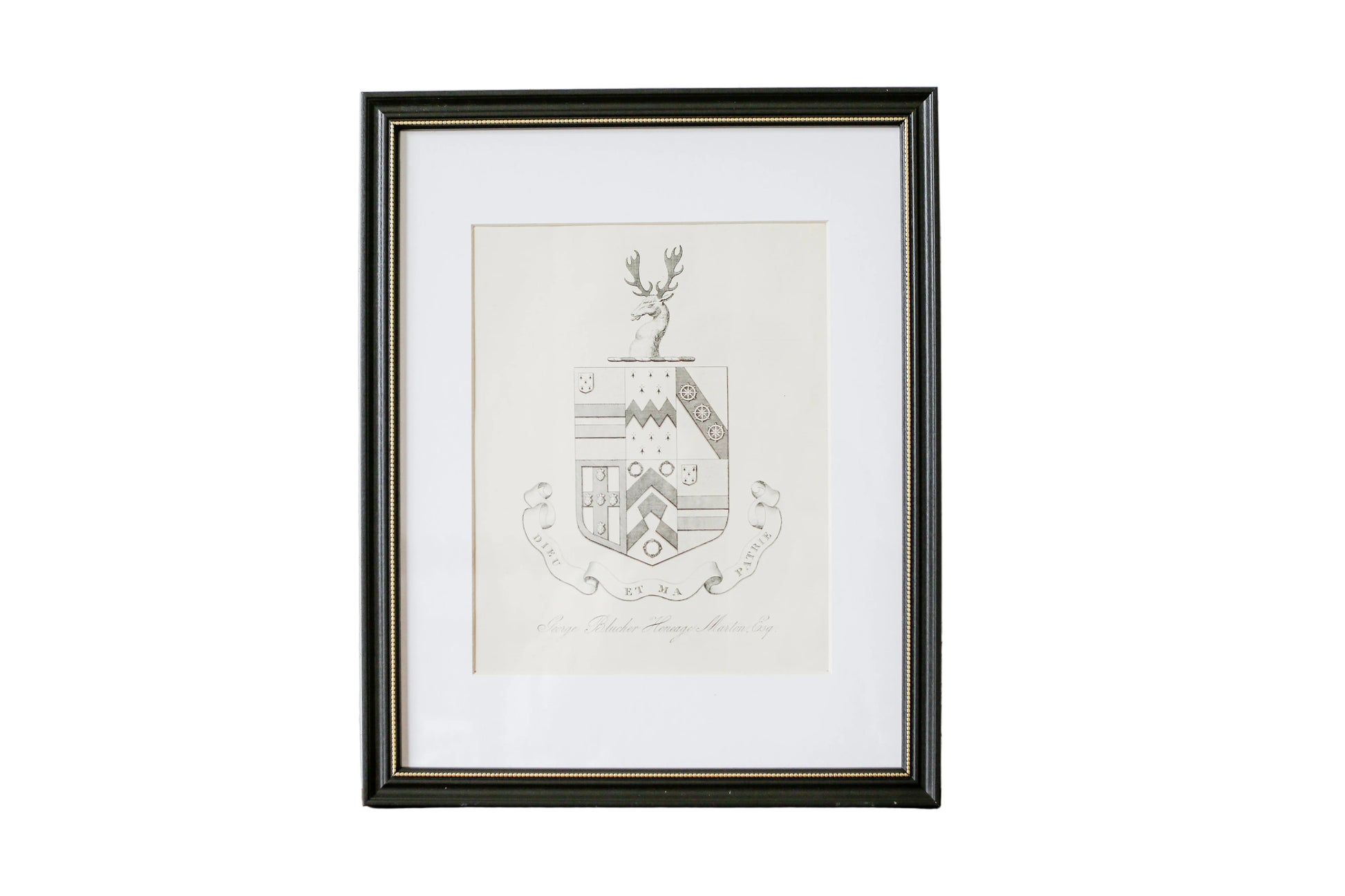 Framed artwork with a deer emblem on a textured wall.