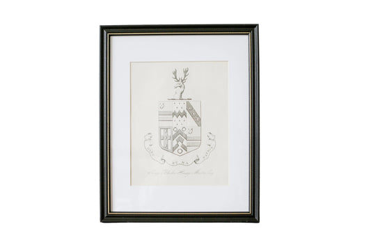 Framed artwork with a deer emblem on a textured wall.