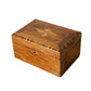 A rectangular wooden box with a hinged lid, featuring an inlaid geometric star pattern on the top and a small keyhole cutout on the front, shown on a plain white background.
