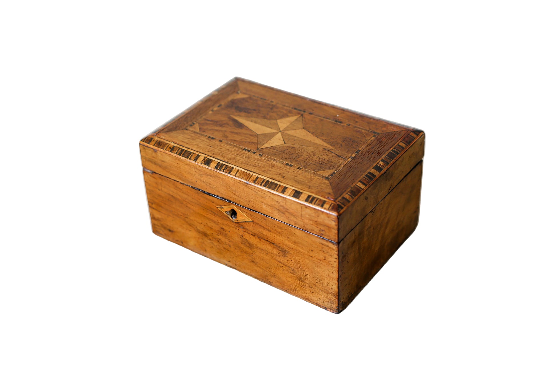 A rectangular wooden box with a hinged lid, featuring an inlaid geometric star pattern on the top and a small keyhole cutout on the front, shown on a plain white background.