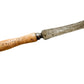 Vintage tool with a wooden handle on a textured beige background