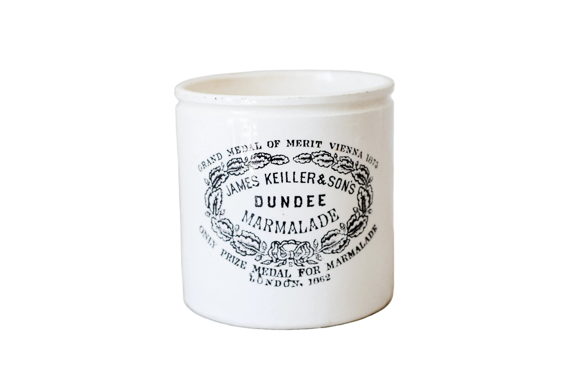 White ceramic jar with black text and design on a light wooden surface