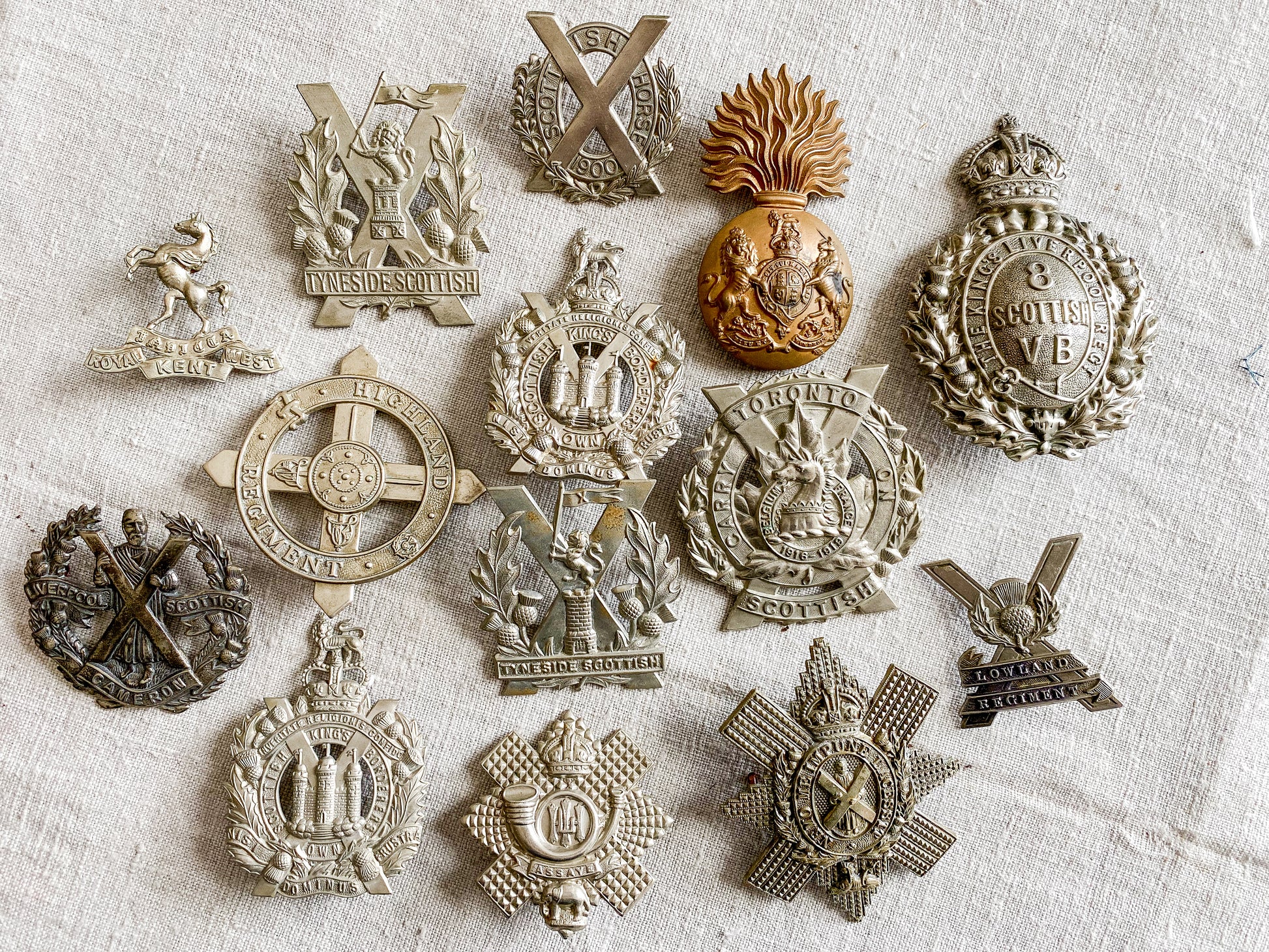 Collection of military badges on a textured fabric background