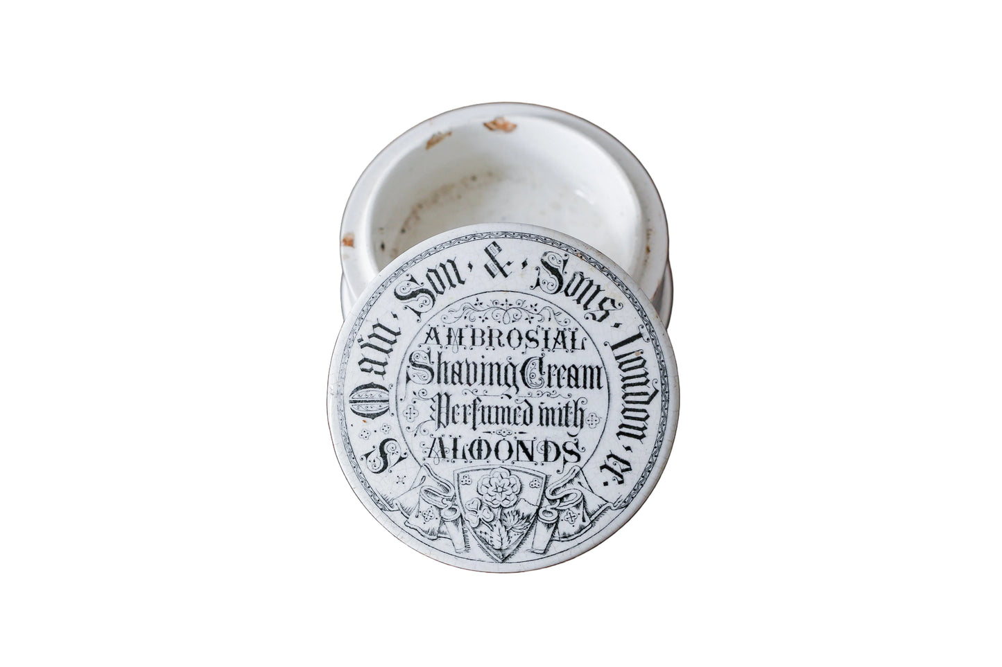 Vintage shaving cream container with a label on a wooden surface