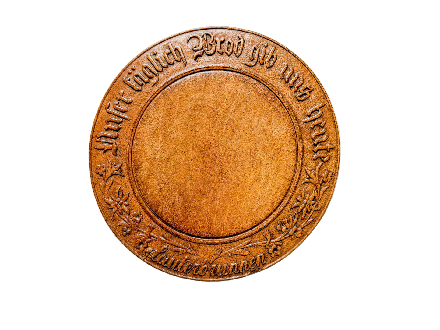 Wooden round sign with engraved text on a white background