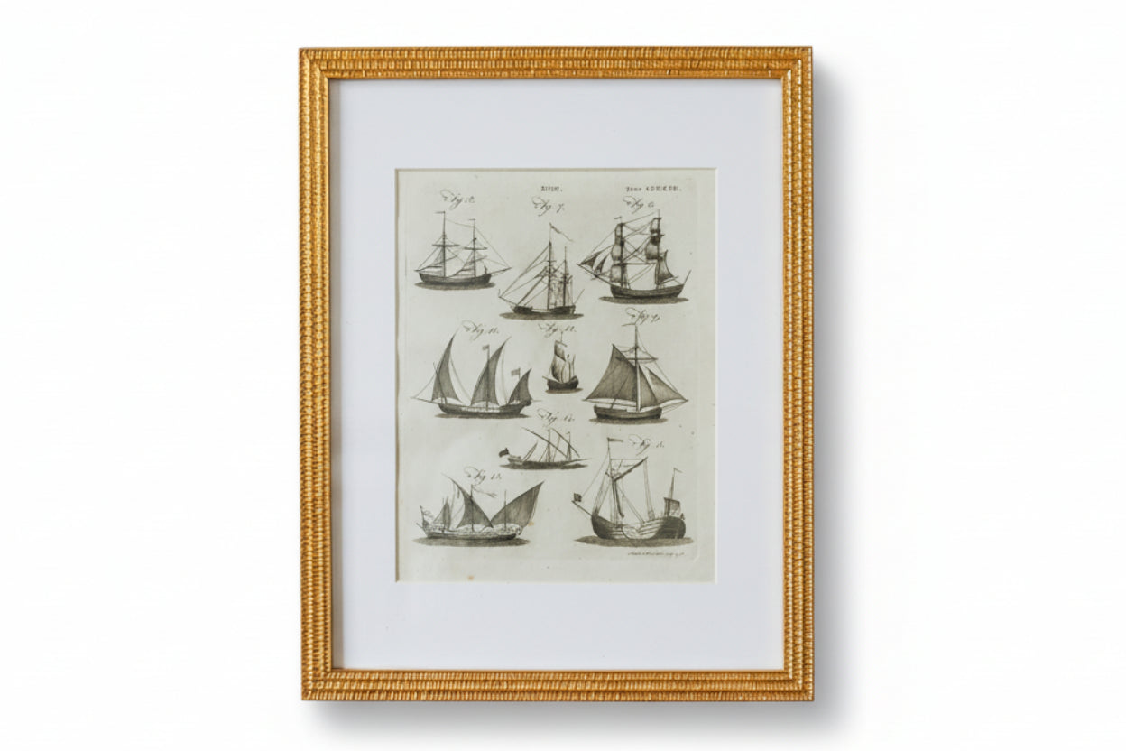 Framed artwork of vintage ship illustrations on a textured wall.