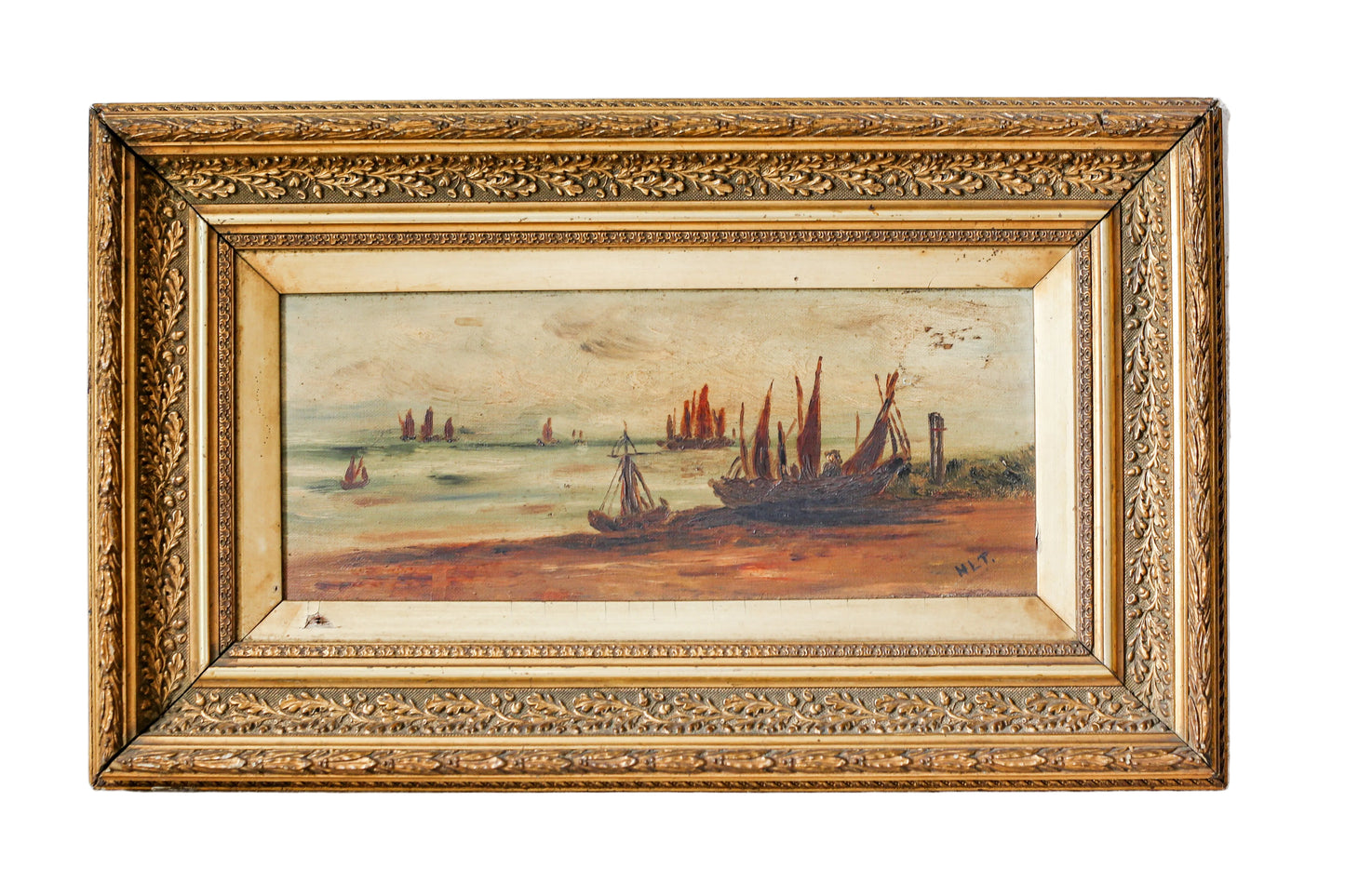 Framed painting of a coastal scene with boats on a white wall.