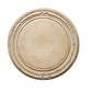 Round wooden cutting board with decorative edge on a light gray surface