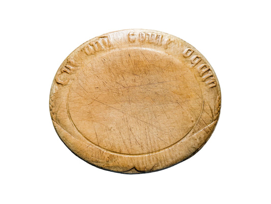 Wooden cutting board with engraved text on a gray surface
