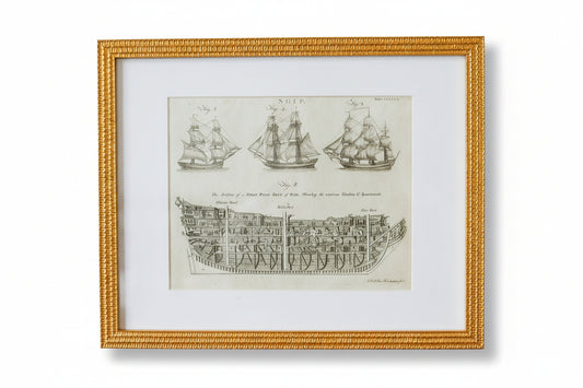 Framed print of a ship diagram on a textured wall.