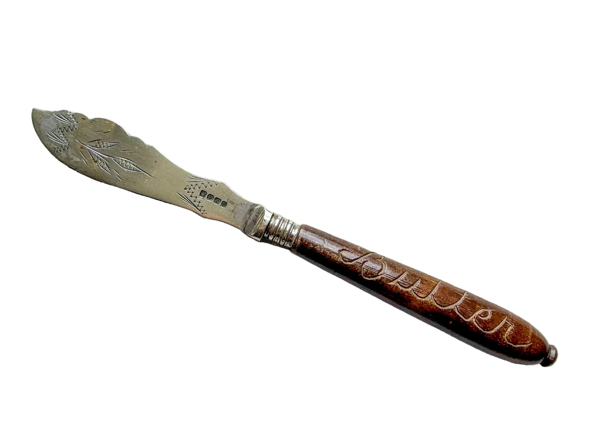Vintage knife with a decorative handle on a textured gray surface