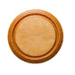 Round wooden coaster on a light gray textured surface
