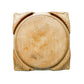 Wooden cutting board with decorative edges on a light gray surface
