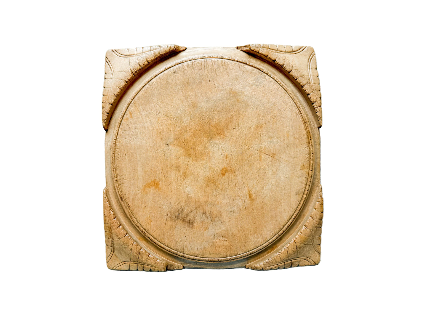 Wooden cutting board with decorative edges on a light gray surface