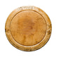 Round wooden cutting board with visible grain and texture on a light gray background