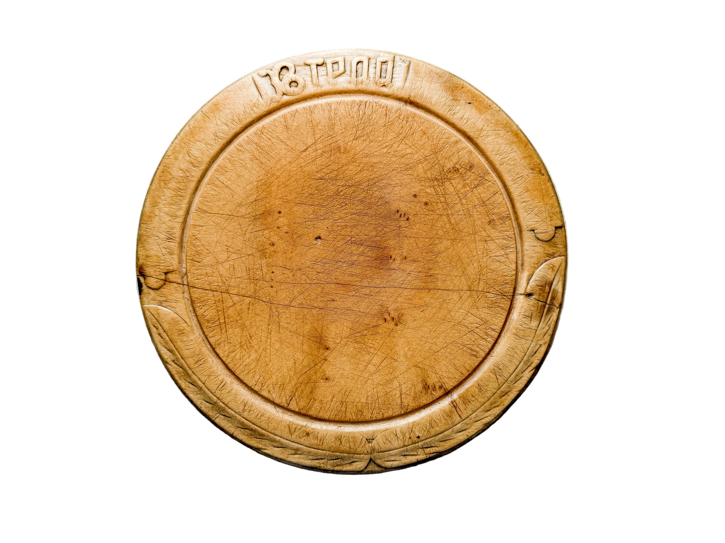 Round wooden cutting board with visible grain and texture on a light gray background