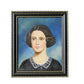 Framed portrait of a woman with dark hair and a white collar on a textured wall.
