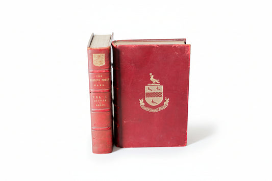 Two red books with a visible emblem on a white background