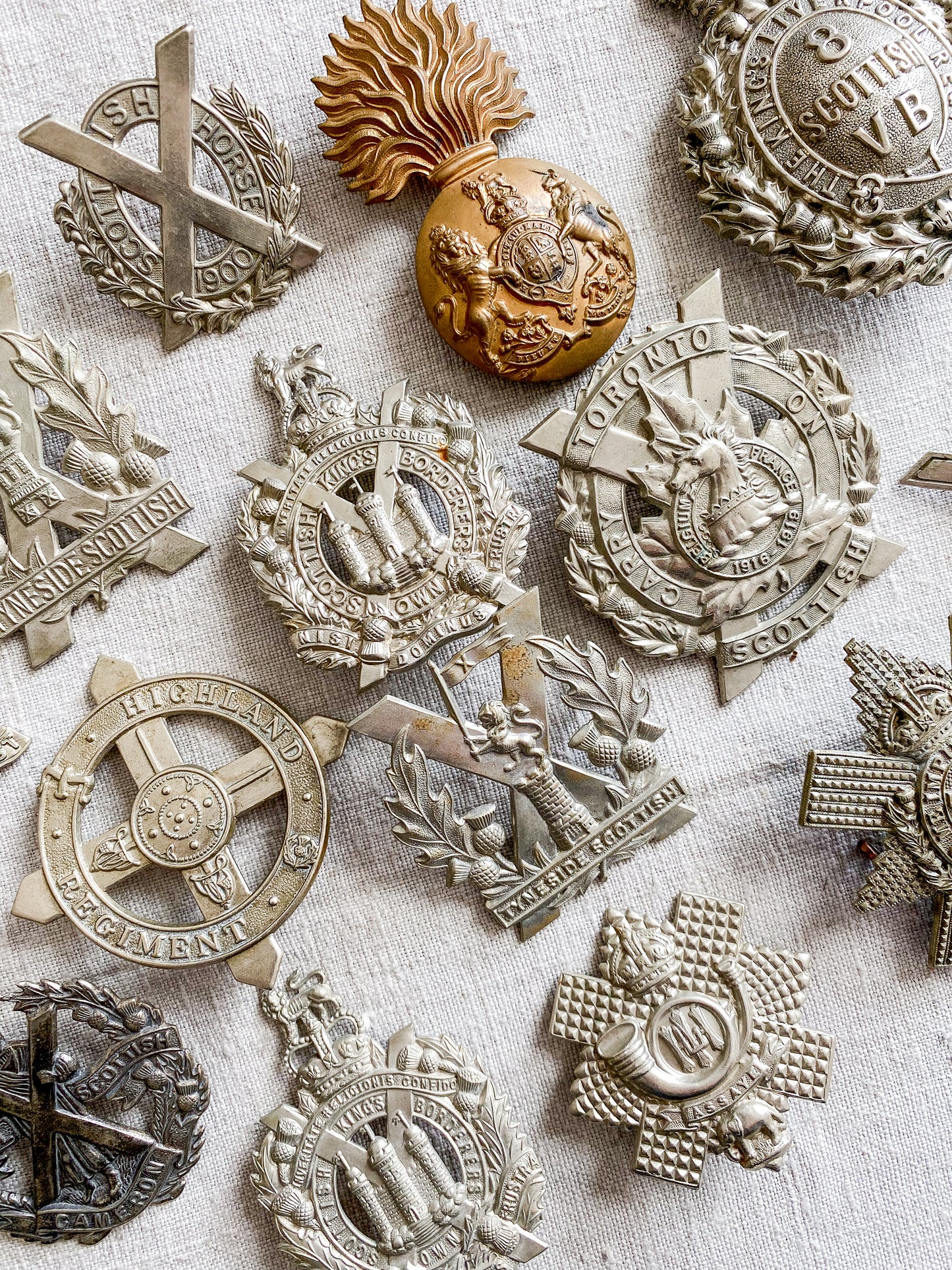 Collection of military badges on a textured surface