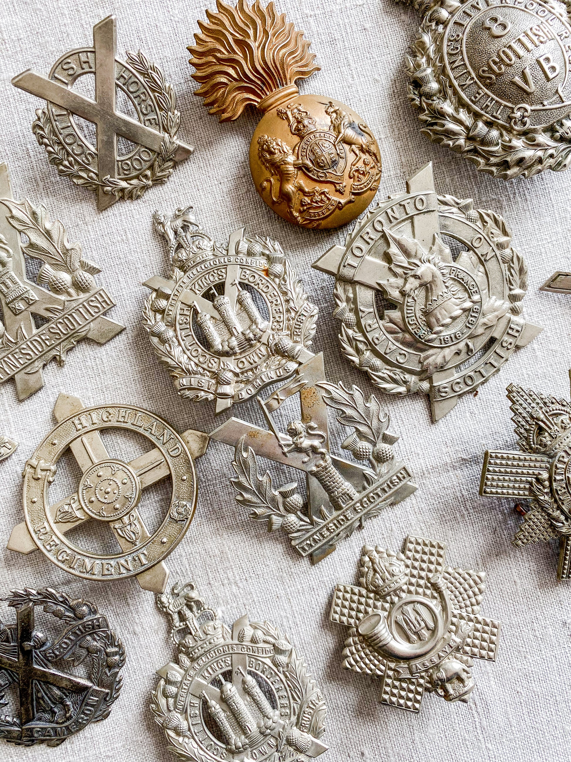 Collection of military badges on a textured surface