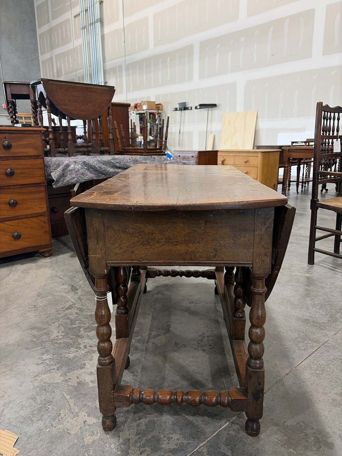 18th century Georgian oak gateleg dining table with spindle stretches and drawer