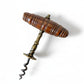 Vintage corkscrew with wooden handle on a textured fabric background