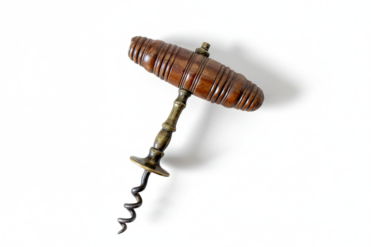 Vintage corkscrew with wooden handle on a textured fabric background