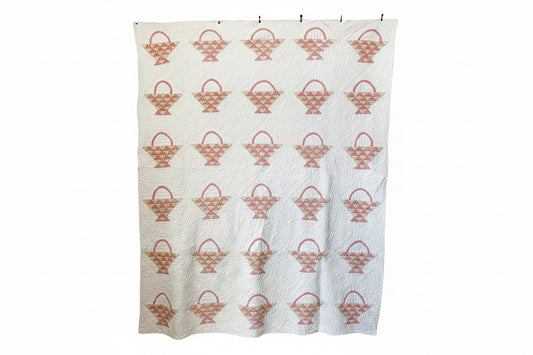 Quilt with basket pattern on a white background