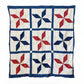Quilt with red and blue star pattern on a white background