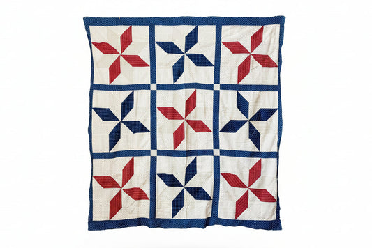 Quilt with red and blue star pattern on a white background