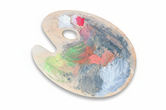 Paint palette with colorful paint strokes on a wooden surface