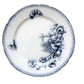Decorative plate with black floral design on a light beige background