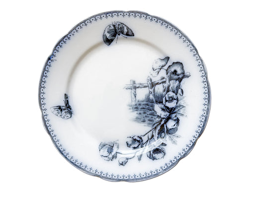 Decorative plate with black floral design on a light beige background